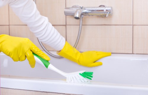 Worker removing dust and residue from newly fitted surfaces